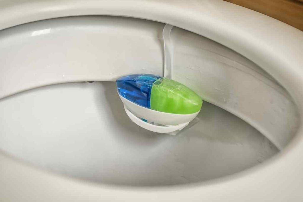 When a toilet rim block gets flushed, it's likely to get caught deeper in the toilet. Call a plumber to get this removed.